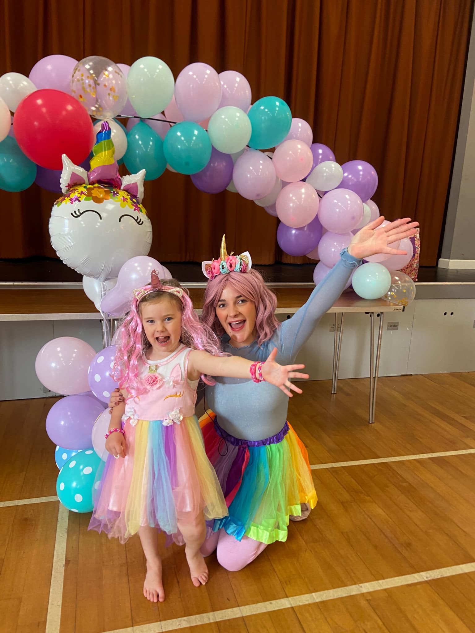 Party entertainer and child at a unicorn themed party